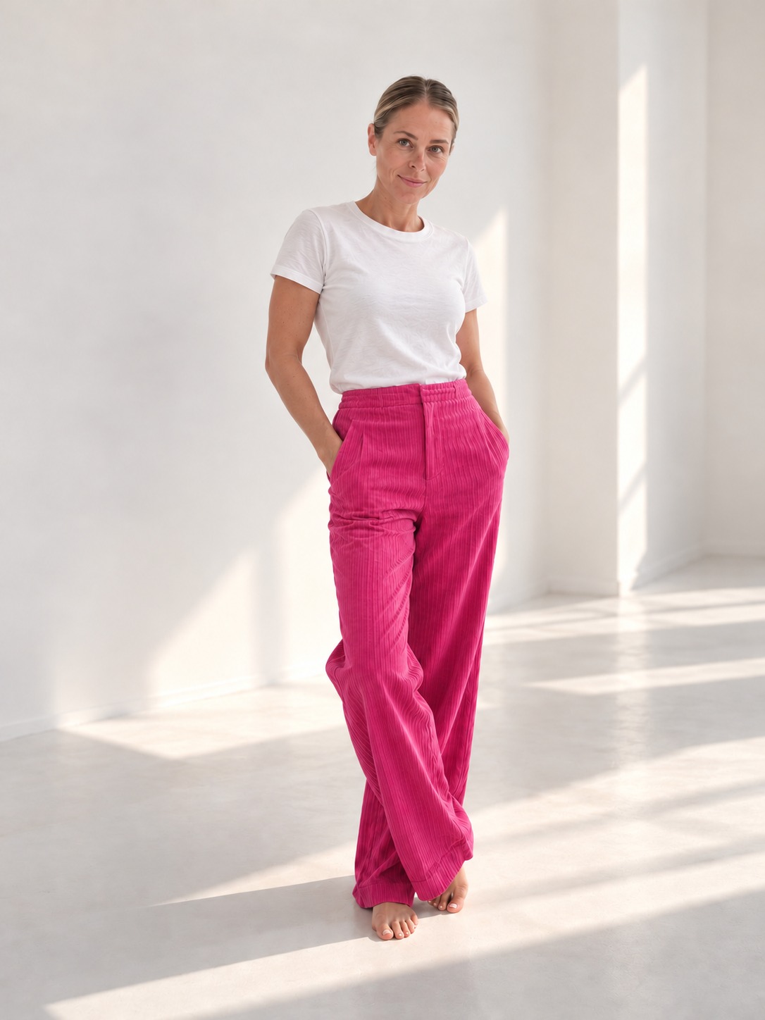 Christina Michael in pink trousers and a white T-shirt